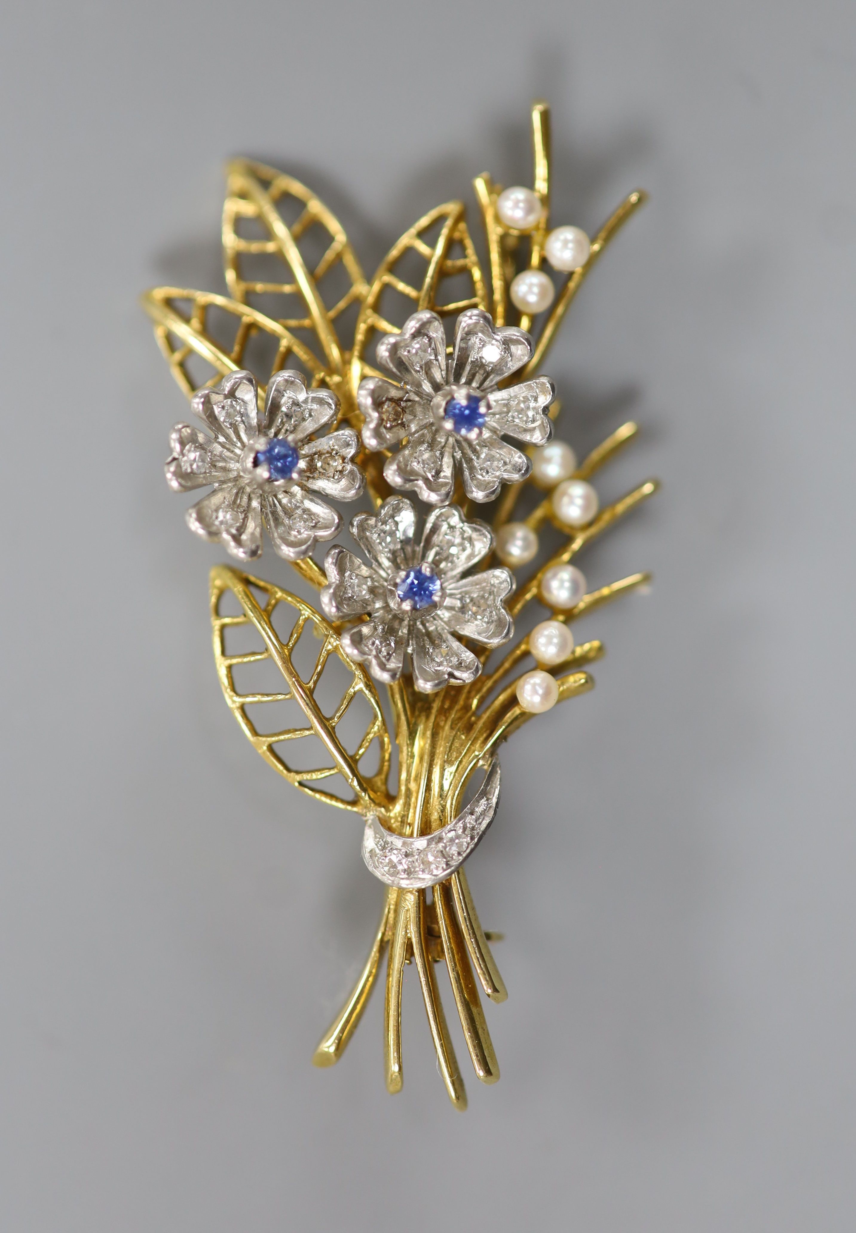 A modern two colour 14ct gold, sapphire, diamond and seed pearl set floral spray brooch, by Cropp & Farr